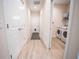 Bright hallway with light wood flooring and access to laundry and bedrooms at 871 Cr 548, Bushnell, FL 33513