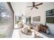 Relaxing screened porch with wicker furniture, overlooking the backyard at 871 Cr 548, Bushnell, FL 33513