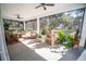 Relaxing screened porch with wicker furniture and lush landscaping at 871 Cr 548, Bushnell, FL 33513