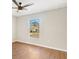 Spacious bedroom featuring wood floors and a large window at 9139 Se 155Th Pl, Summerfield, FL 34491