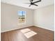 Bedroom featuring wood-look floors, a ceiling fan, and a window that provides natural light at 9139 Se 155Th Pl, Summerfield, FL 34491