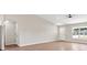 Spacious living room with wood floors, a ceiling fan, and lots of natural light at 9139 Se 155Th Pl, Summerfield, FL 34491