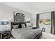 Comfortable bedroom with a bed, nightstands, and large window at 9287 Sw 102Nd Avenue Rd, Ocala, FL 34481