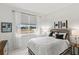 Guest bedroom with a queen bed, nightstand, and window view at 9287 Sw 102Nd Avenue Rd, Ocala, FL 34481
