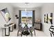 Bright dining area with glass table, four chairs, and large window offering view at 9287 Sw 102Nd Avenue Rd, Ocala, FL 34481