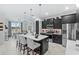 Modern kitchen with dark cabinetry, quartz countertops, and island at 9287 Sw 102Nd Avenue Rd, Ocala, FL 34481
