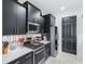 Modern kitchen features sleek black cabinetry, stainless steel appliances, and quartz countertops at 9287 Sw 102Nd Avenue Rd, Ocala, FL 34481