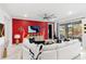 Living area with sectional sofa and a red accent wall at 9287 Sw 102Nd Avenue Rd, Ocala, FL 34481