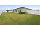 Large backyard with green grass, a small patio and a white fence at 9334 Sw 57Th Ave, Ocala, FL 34476