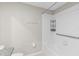 Well lit bathroom with white tile and a full bathtub and shower at 9334 Sw 57Th Ave, Ocala, FL 34476
