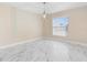 Well-lit room with marble floors, modern light fixture, and a large window with blinds at 9334 Sw 57Th Ave, Ocala, FL 34476