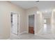 Bright hallway with access to a bathroom and other rooms, showcasing modern flooring at 9334 Sw 57Th Ave, Ocala, FL 34476