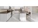Modern kitchen with white cabinetry, granite countertops, and a spacious island with seating at 9334 Sw 57Th Ave, Ocala, FL 34476