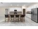 Kitchen area with a central island, modern appliances, and sleek white cabinetry at 9334 Sw 57Th Ave, Ocala, FL 34476