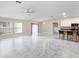 Spacious living room with marble floors, a ceiling fan, and access to kitchen area at 9334 Sw 57Th Ave, Ocala, FL 34476