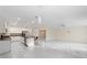 Bright, open living area with marble floors, ceiling fan, and a modern island kitchen at 9334 Sw 57Th Ave, Ocala, FL 34476