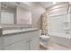 Bathroom with tub shower, toilet and granite countertop at 961 Lido Dr, Howey In The Hills, FL 34737
