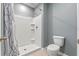 Bathroom with shower, toilet and patterned shower curtain at 961 Lido Dr, Howey In The Hills, FL 34737