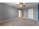 Spacious bedroom with ceiling fan and access to bathroom at 961 Lido Dr, Howey In The Hills, FL 34737