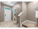Front entry with tile flooring, half bath, and carpeted stairs at 961 Lido Dr, Howey In The Hills, FL 34737