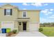 Two-story townhome with attached garage and landscaping at 961 Lido Dr, Howey In The Hills, FL 34737