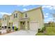 Front view of a two-story townhome with double garage at 961 Lido Dr, Howey In The Hills, FL 34737