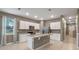 Modern kitchen with white cabinets, granite countertops, and island at 961 Lido Dr, Howey In The Hills, FL 34737