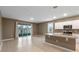 Open kitchen with island, stainless steel appliances, and patio access at 961 Lido Dr, Howey In The Hills, FL 34737