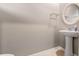 Small powder room with pedestal sink and decorative mirror at 961 Lido Dr, Howey In The Hills, FL 34737