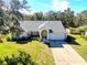 Single-story home with a large yard at 10108 Silver Bluff Dr, Leesburg, FL 34788