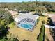 Aerial view of home with pool and screened enclosure at 10108 Silver Bluff Dr, Leesburg, FL 34788