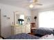 Twin bedroom with navy and white bedding and a dresser at 10108 Silver Bluff Dr, Leesburg, FL 34788