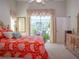 Bright bedroom with a king-size bed and access to a patio at 10108 Silver Bluff Dr, Leesburg, FL 34788