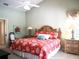 Spacious bedroom with king-size bed and wood furniture at 10108 Silver Bluff Dr, Leesburg, FL 34788