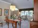 Elegant dining room with hardwood table and chandelier at 10108 Silver Bluff Dr, Leesburg, FL 34788