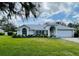 Charming single-story home featuring a well-manicured lawn and an attached two-car garage at 10108 Silver Bluff Dr, Leesburg, FL 34788