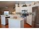 White kitchen with stainless steel appliances and an island at 10108 Silver Bluff Dr, Leesburg, FL 34788