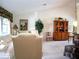 Living room with a white sofa and striped armchairs at 10108 Silver Bluff Dr, Leesburg, FL 34788