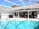 Relaxing pool area with covered patio at 10108 Silver Bluff Dr, Leesburg, FL 34788