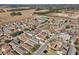 Aerial view of a residential neighborhood with a large empty lot at 12306 Ne 48Th Way, Oxford, FL 34484