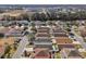 A sunny aerial view of the neighborhood, showing rooftops and landscaping at 12306 Ne 48Th Way, Oxford, FL 34484