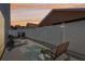 Outdoor patio area, fenced backyard, and lounge chairs at dusk at 12306 Ne 48Th Way, Oxford, FL 34484