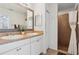 Bathroom featuring double sinks, white cabinets and a stand-up shower at 12306 Ne 48Th Way, Oxford, FL 34484
