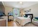 Cozy bedroom with wood floors, a desk, and a comfortable bed at 12306 Ne 48Th Way, Oxford, FL 34484