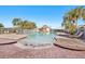 A community pool featuring a zero entry walk-in area, surrounded by palm trees at 12306 Ne 48Th Way, Oxford, FL 34484