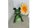 Whimsical backyard decor featuring a frog holding a flower at 12306 Ne 48Th Way, Oxford, FL 34484