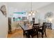 Bright dining area with a rustic wooden table and chairs, adjacent to kitchen at 12306 Ne 48Th Way, Oxford, FL 34484