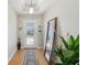 Bright entryway with a decorative mirror, stylish rug, and a plant, creating a welcoming ambiance at 12306 Ne 48Th Way, Oxford, FL 34484