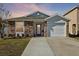 Charming single-Gathering home with stone accents, a well-manicured lawn, and an attached two-car garage at 12306 Ne 48Th Way, Oxford, FL 34484