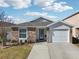 Charming one-story home with stone facade and two-car garage at 12306 Ne 48Th Way, Oxford, FL 34484